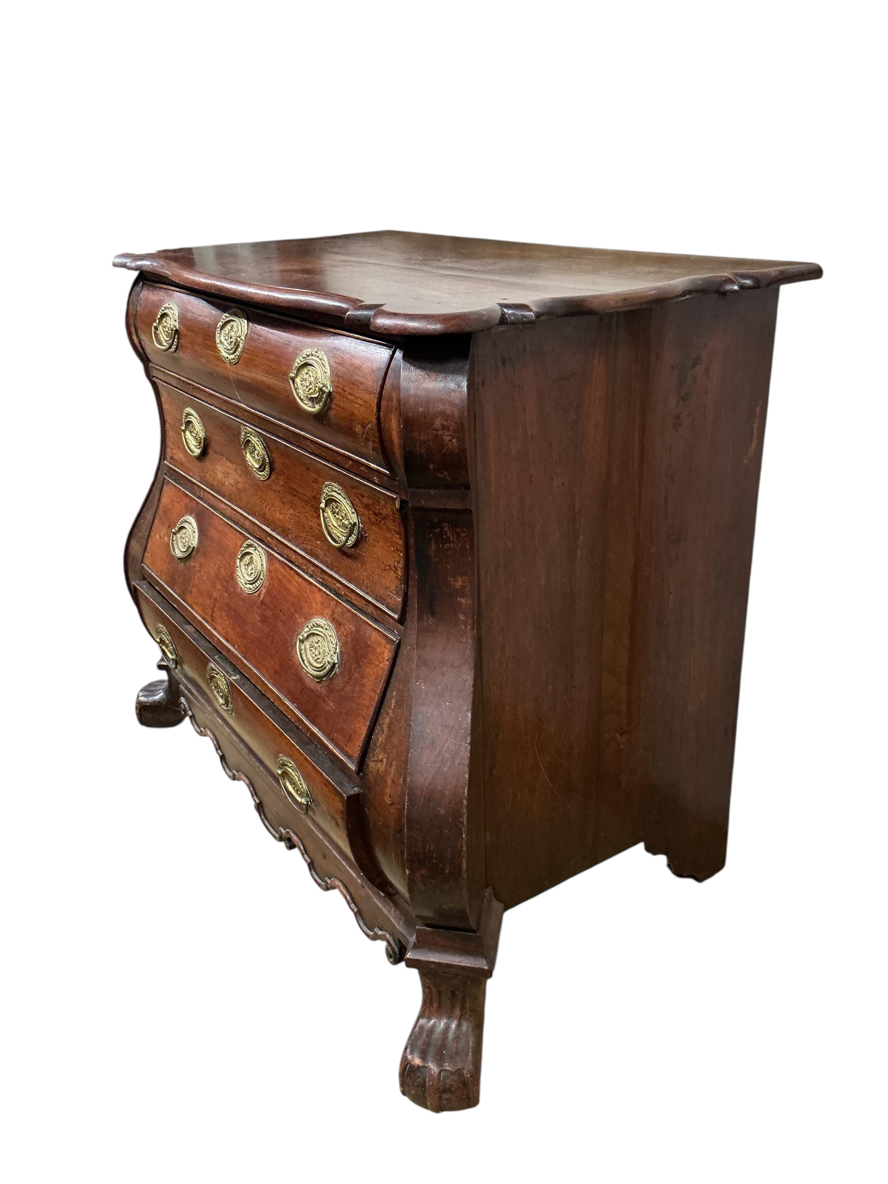 An 18th century Dutch oak bombe chest, of four long drawers, width 106cm, depth 54cm, height 87cm